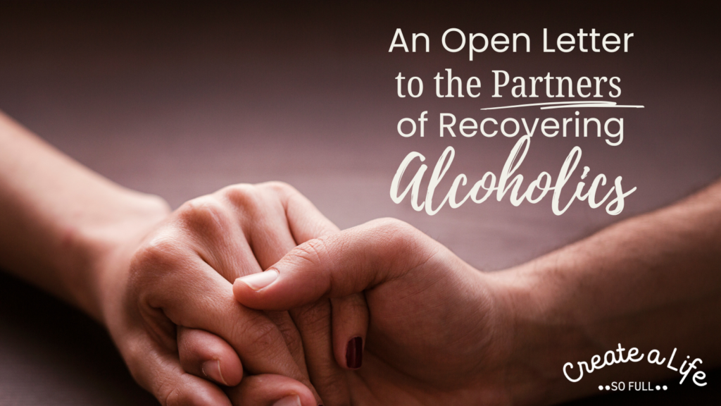 Image: Close up of a male and female hand, resting on a wooden table. Title of the blog post "an open letter to the partners of recovering alcoholics" is overlaid in white text.